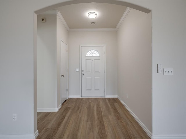 doorway to outside with crown molding and hardwood / wood-style flooring