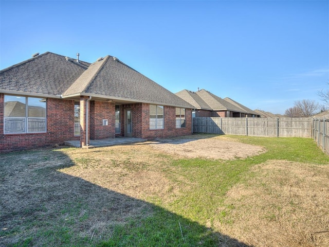 back of house featuring a yard