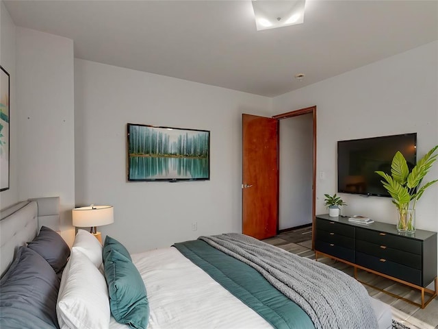 bedroom with hardwood / wood-style flooring