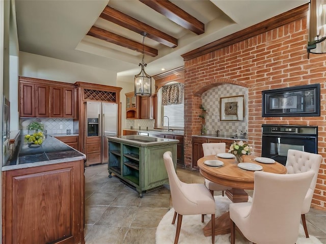 kitchen with black appliances, beamed ceiling, hanging light fixtures, and tasteful backsplash