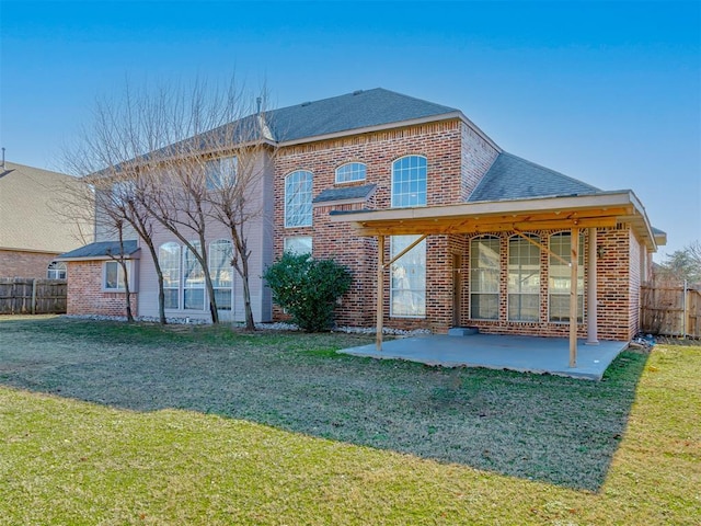 back of house featuring a yard and a patio