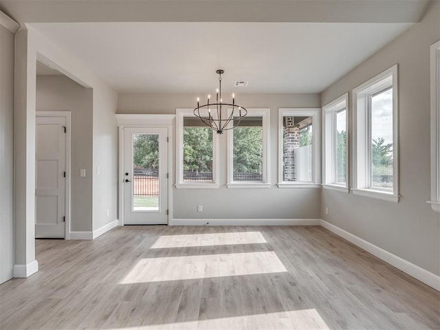 interior space featuring light hardwood / wood-style flooring and a chandelier