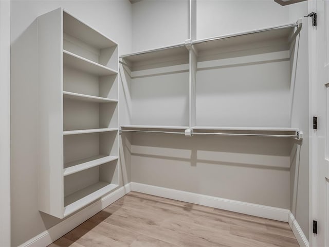 spacious closet with light hardwood / wood-style floors