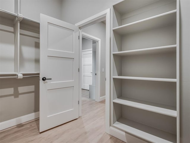 walk in closet featuring light hardwood / wood-style floors