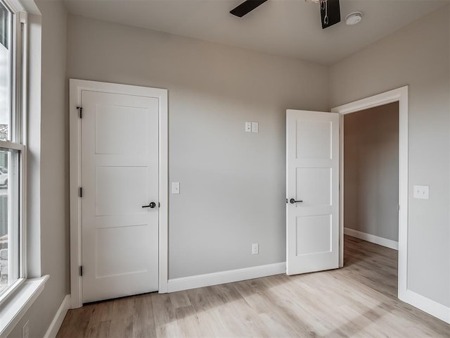 unfurnished bedroom with light hardwood / wood-style floors and ceiling fan