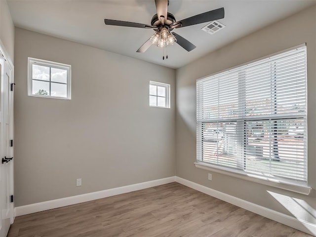 empty room with light hardwood / wood-style floors and ceiling fan