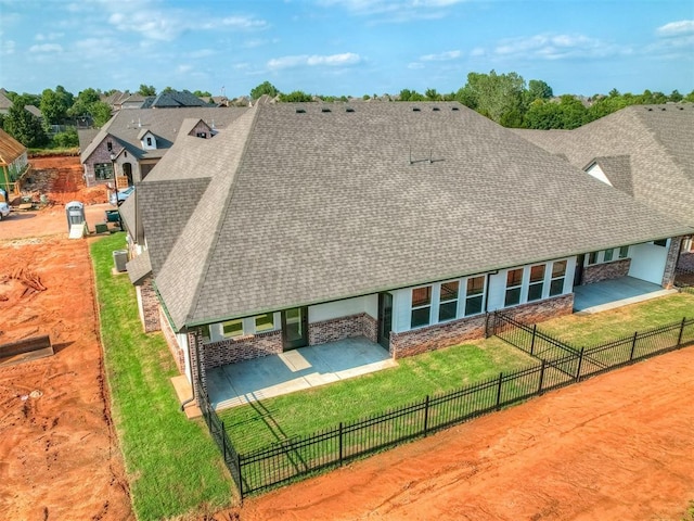 rear view of property with a yard and a patio