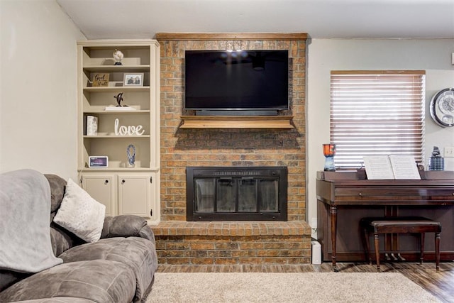 living room with a brick fireplace