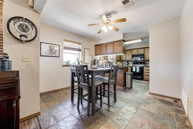 dining space with ceiling fan