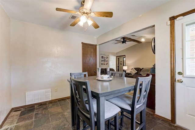 dining area featuring ceiling fan and vaulted ceiling