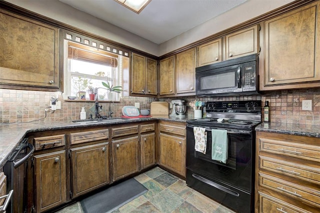 kitchen featuring backsplash, dark stone counters, black appliances, and sink