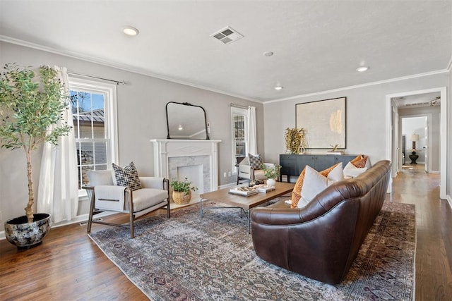 living room featuring a fireplace, dark hardwood / wood-style flooring, and crown molding