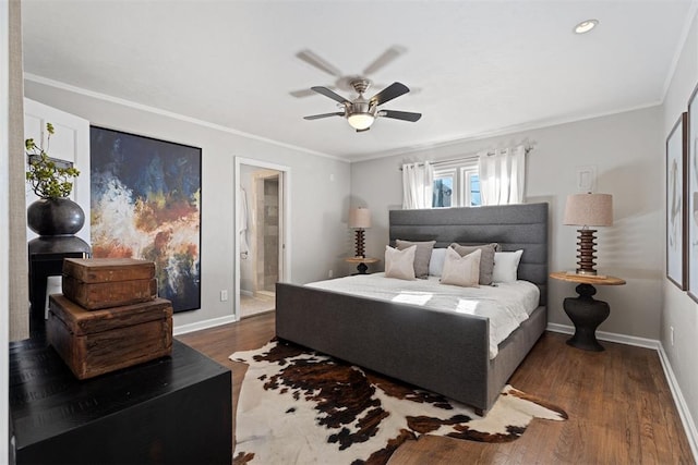 bedroom featuring ceiling fan, ornamental molding, dark wood-type flooring, and connected bathroom