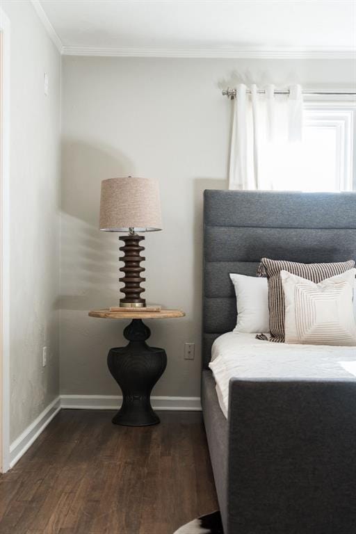 bedroom featuring dark hardwood / wood-style flooring and crown molding