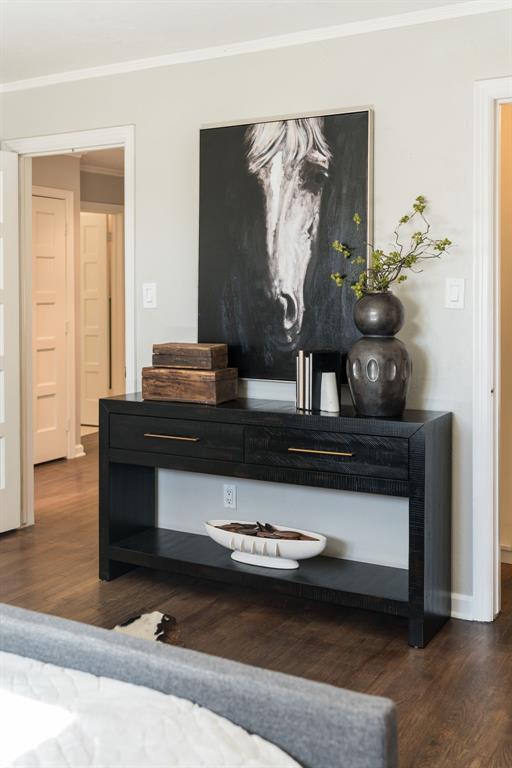 interior details with hardwood / wood-style floors and crown molding