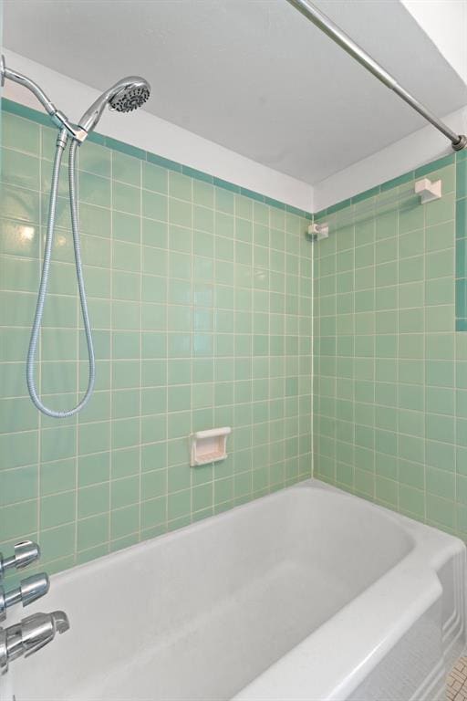 bathroom with tiled shower / bath combo and tile patterned floors