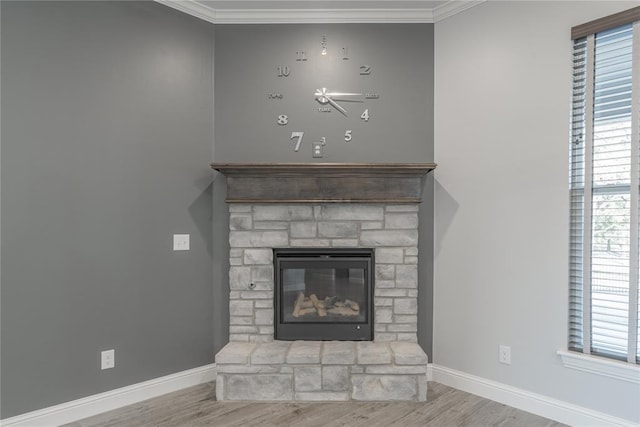 details featuring hardwood / wood-style flooring, ornamental molding, and a fireplace