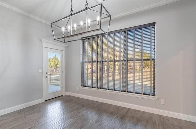 unfurnished dining area with hardwood / wood-style floors and crown molding