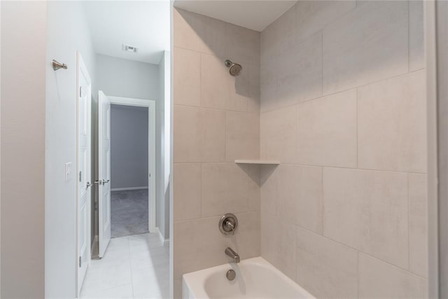 bathroom with tiled shower / bath and tile patterned floors