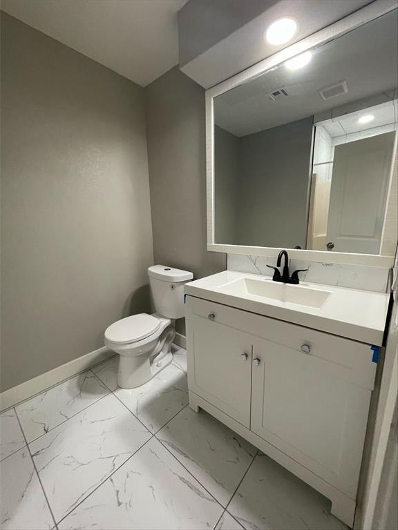 bathroom with vanity and toilet