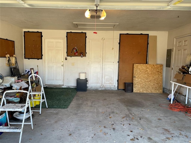 garage featuring electric panel and a garage door opener