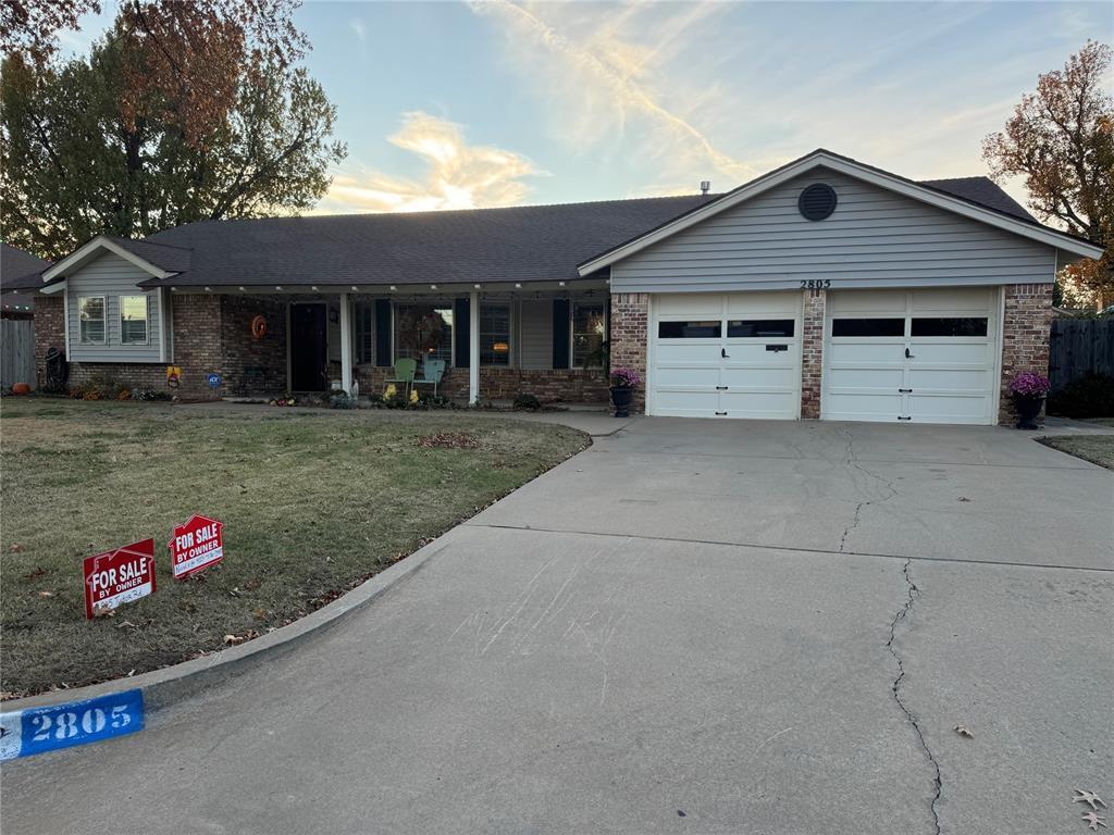 ranch-style home with a lawn and a garage