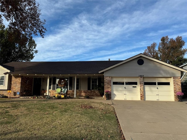 single story home featuring a front lawn, covered porch, and a garage