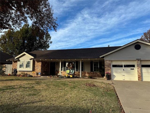 ranch-style home featuring a front yard, a garage, and covered porch