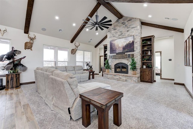 living room with high vaulted ceiling, ceiling fan, a fireplace, beamed ceiling, and light hardwood / wood-style floors