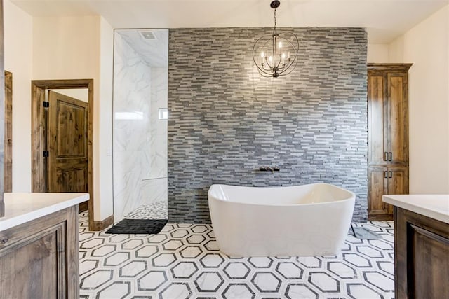 bathroom featuring separate shower and tub, vanity, tile walls, and a notable chandelier