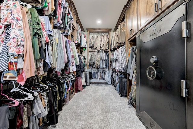 walk in closet featuring light colored carpet