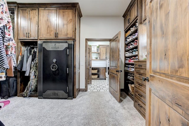 walk in closet featuring light carpet