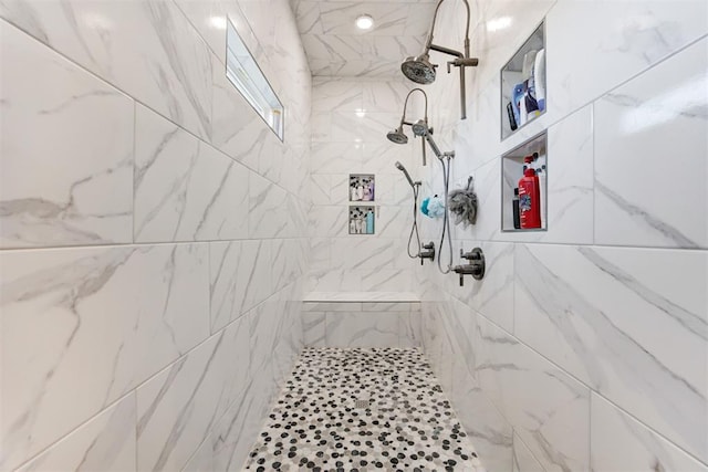 bathroom featuring a tile shower