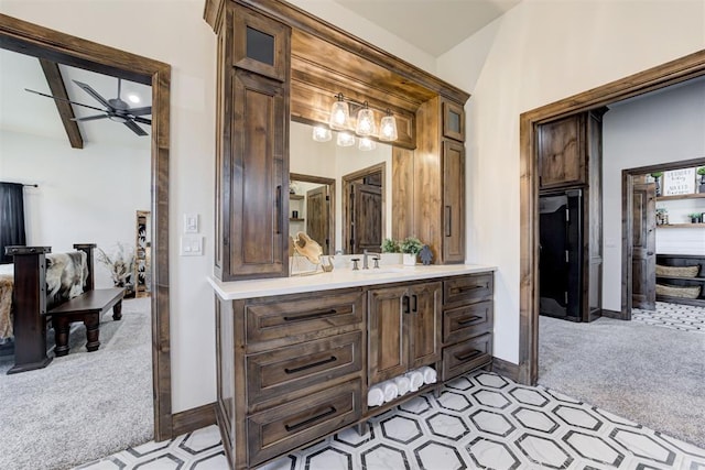 bathroom featuring vanity, ceiling fan, and beamed ceiling