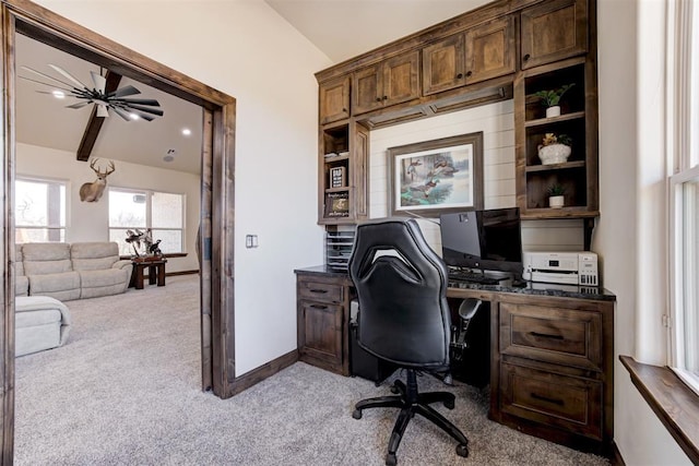 carpeted office space with vaulted ceiling with beams and ceiling fan