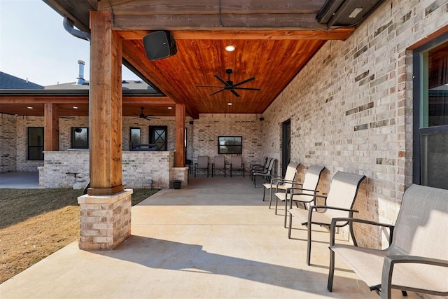 view of patio with a bar and ceiling fan