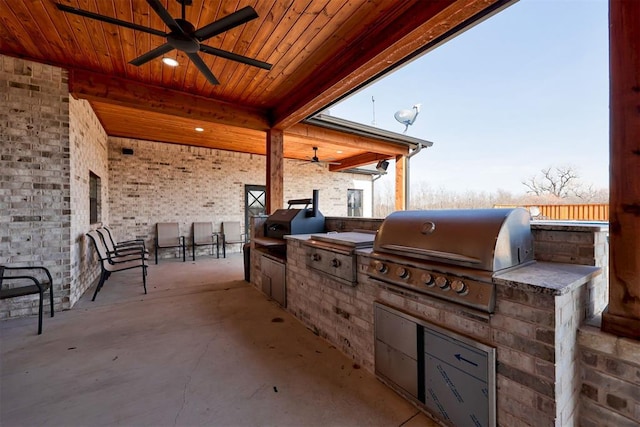 view of patio / terrace featuring ceiling fan, grilling area, and exterior kitchen