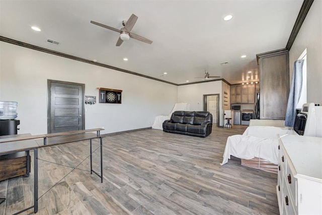 bedroom with ceiling fan, crown molding, and hardwood / wood-style flooring