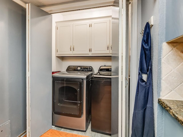 washroom with cabinets and independent washer and dryer