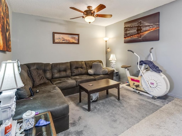 carpeted living room with ceiling fan and a textured ceiling