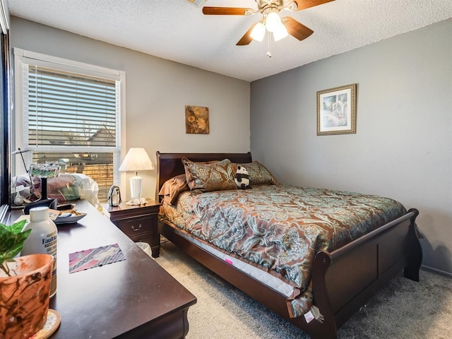 carpeted bedroom featuring a textured ceiling and ceiling fan