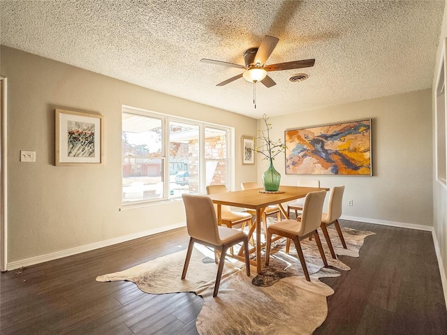 dining area featuring a textured ceiling, ceiling fan, and dark wood-type flooring