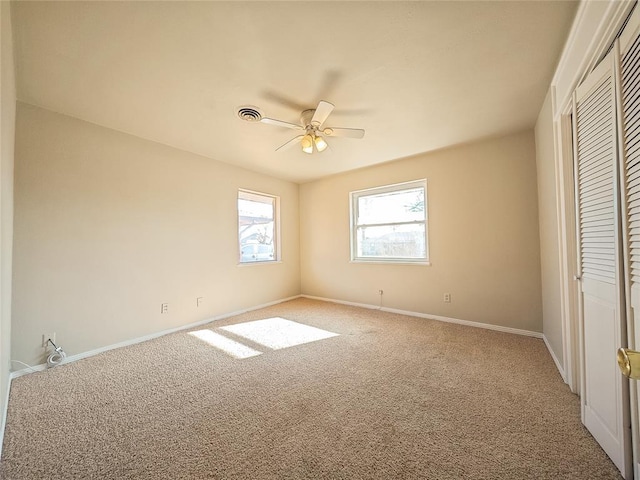 unfurnished bedroom featuring a closet, ceiling fan, and carpet