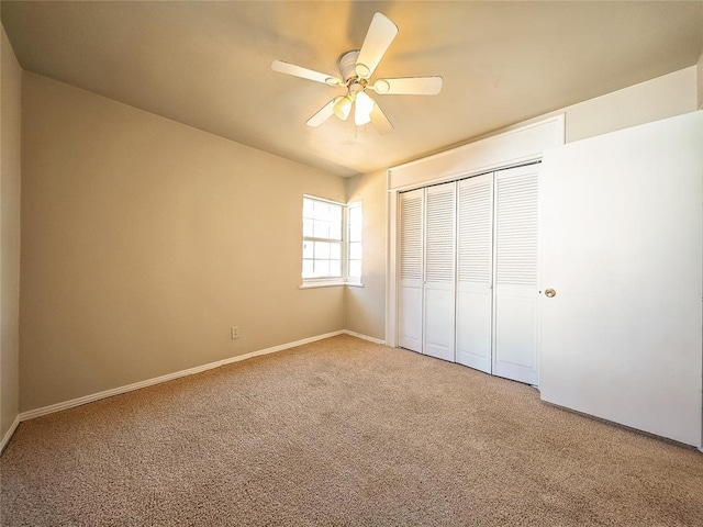 unfurnished bedroom with a closet, ceiling fan, and carpet floors