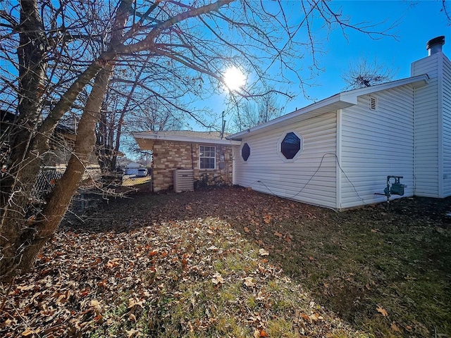 rear view of property featuring cooling unit