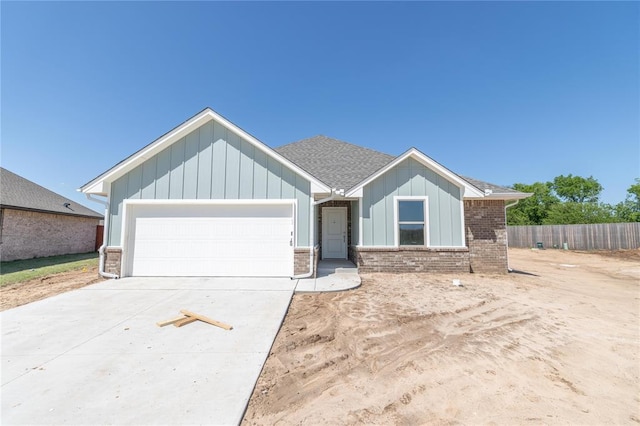 1917 Taines Turn, Norman, OK 73072 - ranch-style house featuring fence, brick siding, board and batten siding, an attached garage, and driveway