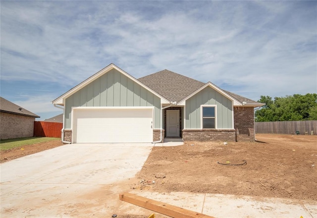 1917 Taines Turn, Norman, OK 73072 - view of front of house with a garage, concrete driveway, board and batten siding, and roof with shingles