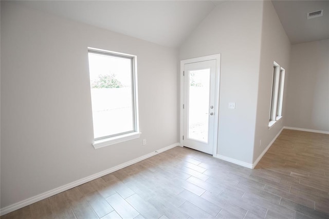 1917 Taines Turn, Norman, OK 73072 - empty room featuring wood finished floors and lofted ceiling