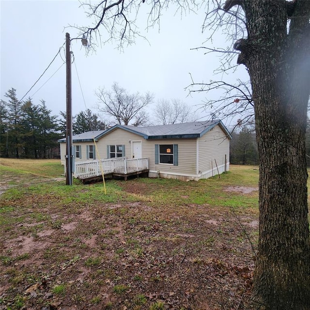 view of front of home featuring a front yard and a deck