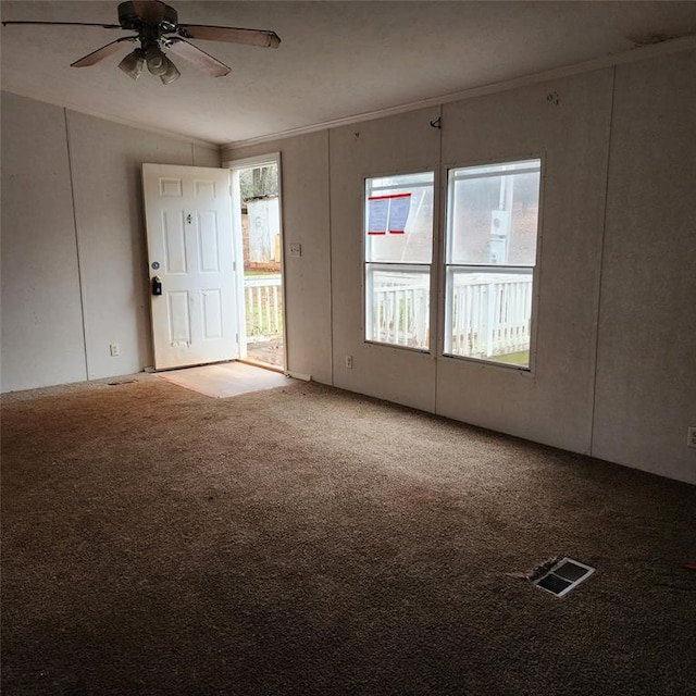 spare room with carpet flooring, vaulted ceiling, ceiling fan, and ornamental molding